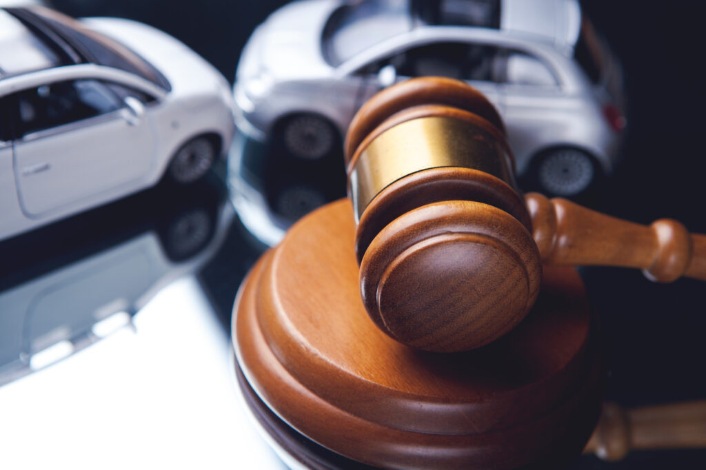 Key Car Accident Lawyer Hiring Considerations - Model of car and gavel. Accident lawsuit or insurance, court case